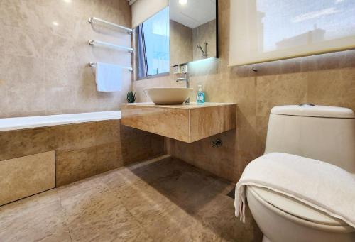a bathroom with a sink and a toilet and a tub at 3min to Pavilion & MRT [1-6Pax] View Menara 118 by MOJI HOME in Kuala Lumpur