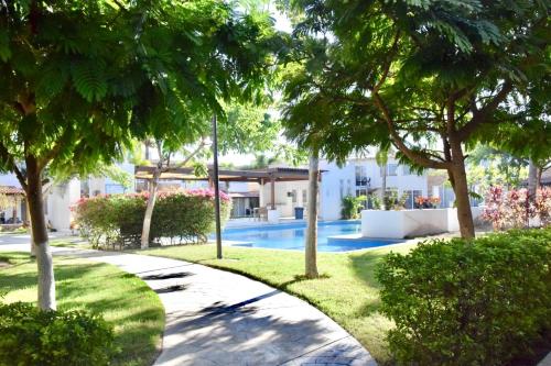 a garden with trees and a swimming pool at Casa Lidia in Las Juntas