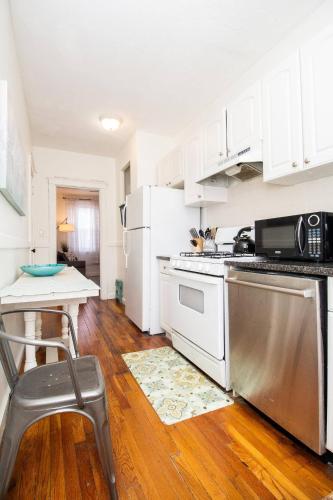 a kitchen with white cabinets and a stainless steel appliance at 05mile to Boston Childrens, Brigham, Dana F, BI in Longwood Station