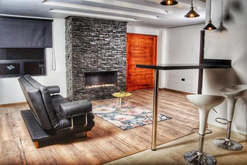 a living room with a chair and a fireplace at El Encanto Hotel Boutique in Duitama