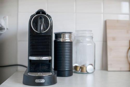 a blender sitting on a counter next to a jar at The Peach Tree 2 Bed Home in Elizabeth