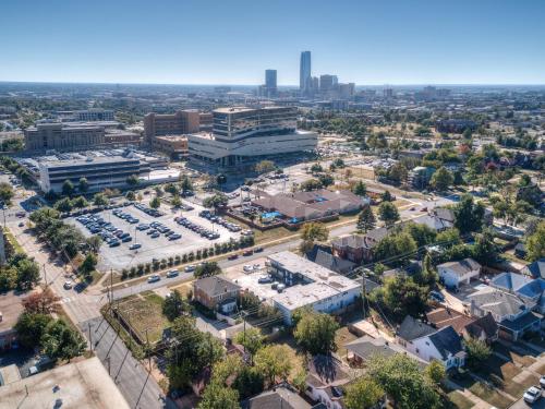 an aerial view of a city with a parking lot at UMC Apartments in Oklahoma City