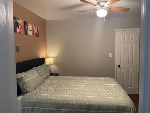 a bedroom with a bed and a ceiling fan at UMC Apartments in Oklahoma City
