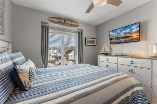 a bedroom with a bed and a window at 114 Austin Ave, Unit 11 in Wildwood