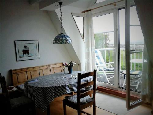 a dining room with a table and a large window at Lagoon on the Wadden See on Wangerooge in Wangerooge