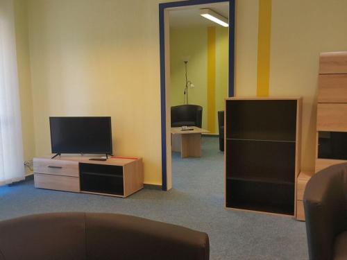 a room with a tv on a dresser and a mirror at Country house Wachendorf in Bruchhausen-Vilsen