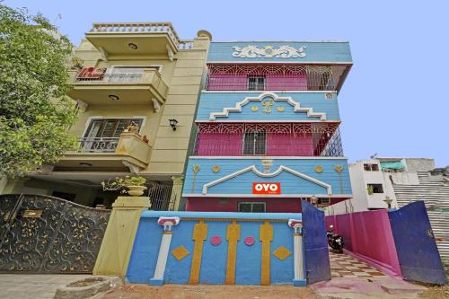 a colorful building with a gate in front of it at Super OYO Arunachala Guest House Near PVR SPI Palazzo Chennai in Chennai