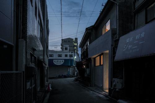 an empty alley with buildings in an asian city at SOUQ Renovated Townhouse in Himeji Quiet Market District in Himeji
