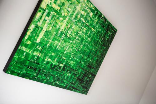 a green emerald is hanging on a wall at Nightcap at St Albans Hotel in St Albans