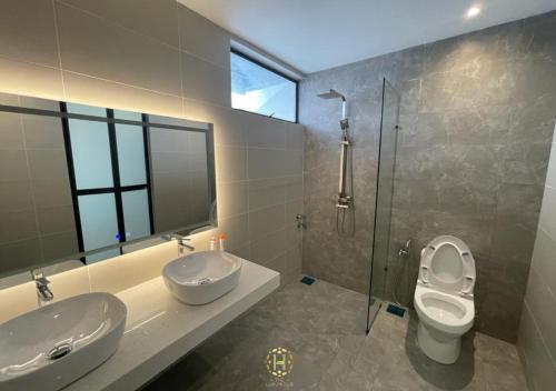 a bathroom with two sinks and a toilet and a shower at The Luxurious 168 Cruise, Melaka in Malacca