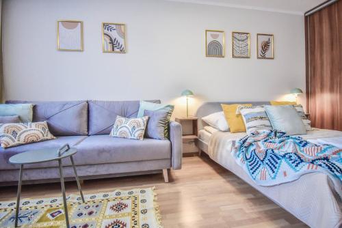 a living room with a couch and a table at Apartamenty na Wyspie - Zdrojowa in Świnoujście