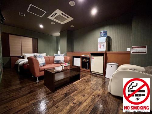 a waiting room with a couch and a no smoking sign at Hotel Asian Color (Adult Only) in Tokyo
