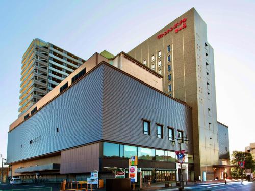 a building with a sign on the side of it at Iwaki Washington Hotel in Iwaki