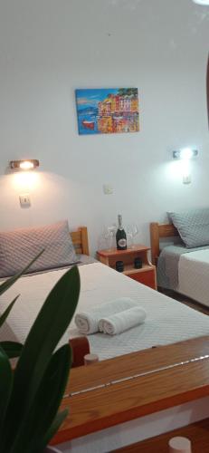 a bedroom with two beds and a painting on the wall at Hermes in Kavos