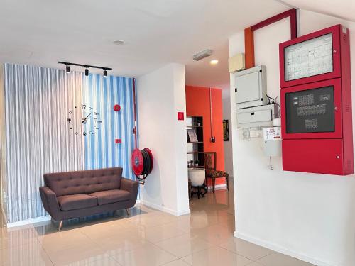 a living room with a couch in a hospital room at BEAR HOTEL at NILAI in Nilai