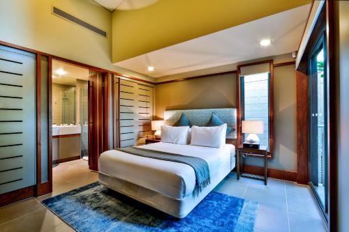 a bedroom with a large bed and a window at Yacht Club Villas on Hamilton Island by HIHA in Hamilton Island