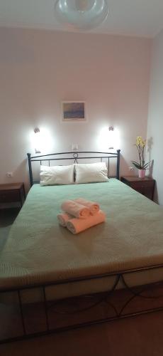 a bed with two towels sitting on top of it at Hermes in Kavos