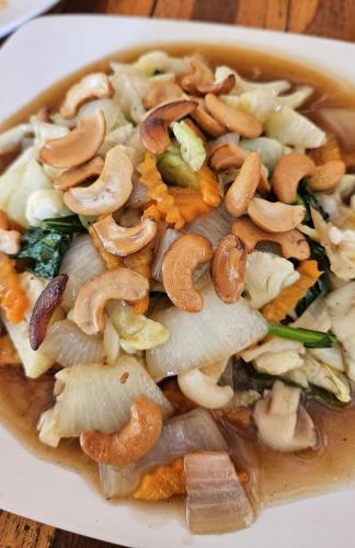 a bowl of food with mushrooms on a table at Seaside Sanctuary Bungalows in Ko Lanta