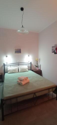 a bedroom with a bed with two towels on it at Hermes in Kavos
