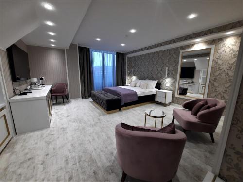 a large hotel room with a bed and a bathroom at Queen Palace in Novi Sad