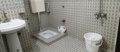 a small bathroom with a sink and a toilet at Hotel Abbasi Palace in Rawalpindi