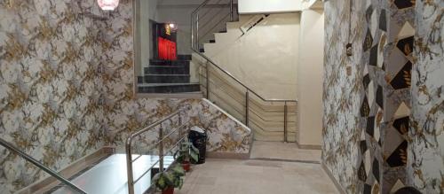 a staircase in a building with a red door at Hotel Abbasi Palace in Rawalpindi