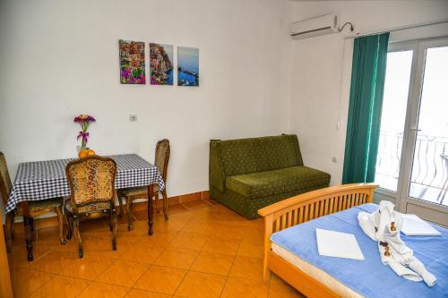 a room with a table and a chair and a dining room at Studios Kalina in Budva