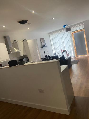 a room with a kitchen and a living room at Enfield homes in London