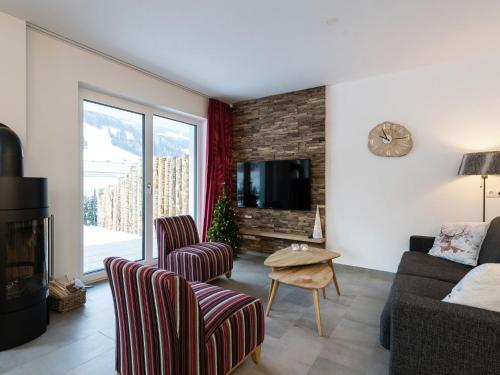 a living room with a couch and a fireplace at Modern Holiday Home in Leogang with Private Sauna in Leogang