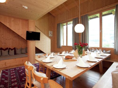 a dining room with a large wooden table with chairs at Apartment in Ramsau im Zillertal with sauna in Ramsau im Zillertal