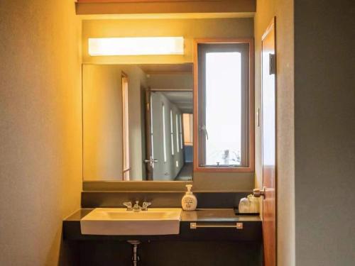 a bathroom with a sink and a mirror at Izu One Club - Vacation STAY 10406v in Futo