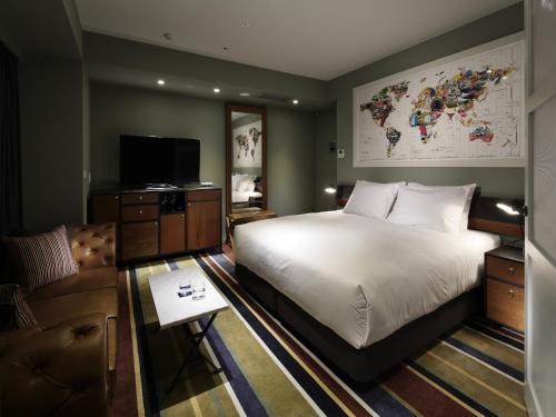 a hotel room with a large bed and a couch at Shinjuku Granbell Hotel in Tokyo
