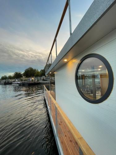 a round window on the side of a building next to the water at Prague Stream in Prague