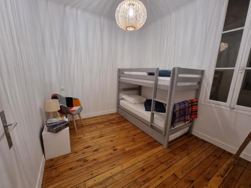 a small room with two bunk beds in it at T3 de 70m2 5/7 couchages in Cauterets