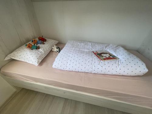 a small bed with two stuffed animals sitting on it at Arabela Lux Villa in Pakoštane