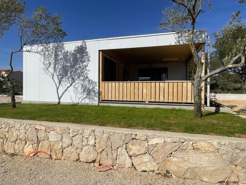 a modern house with a stone wall at Arabela Lux Villa in Pakoštane