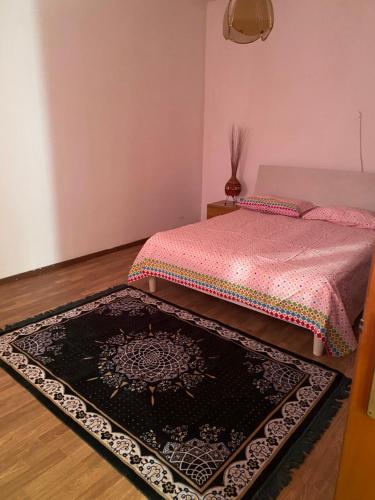 a bedroom with a bed and a rug on the floor at Rafin’s turistico agricoltura in Malcontenta