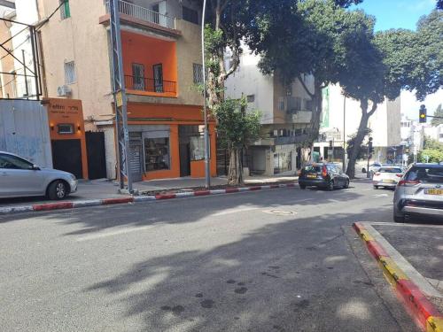 a street with cars parked on the side of the road at Fellini Fortunella terrace (talpiot) in Haifa
