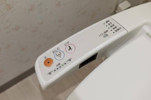a close up of a toilet with a control panel at Bios Sapporo in Sapporo