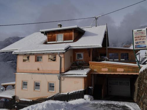 a house with a snow covered roof on a mountain at Group Holiday Home in Hippach with dreamy views in Hippach