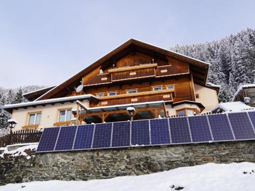 a house with solar panels in the snow at Group Holiday Home in Hippach with dreamy views in Hippach