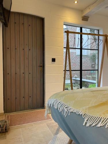 a bedroom with a large sliding door and a bed at B&b kleinen bosch in Beveren