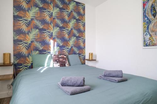 a blue bed with two pillows on top of it at Maison de vacances avec piscine Les Sables d'Olonne 6 personnes in Les Sables-d'Olonne