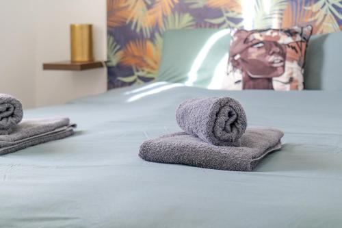 a bed with two towels on top of it at Maison de vacances avec piscine Les Sables d'Olonne 6 personnes in Les Sables-d'Olonne