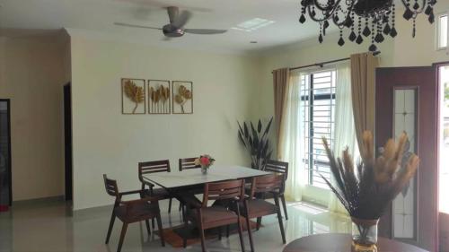 a dining room with a table and chairs at Anugerah Residence Langkawi in Pantai Cenang