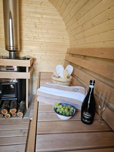 a sauna with a bottle of wine and a bowl of grapes at Boutique Resort OSMA in Malinska