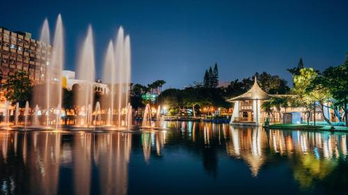 a group of water fountains in a city at night at Holiday Inn Express Taichung Park by IHG in Taichung