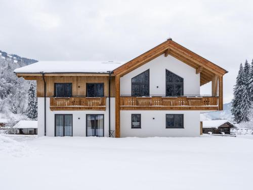a house in the snow with snow at Luxury Chalet in Saalbach Hinterglemm with Sauna in Saalbach Hinterglemm
