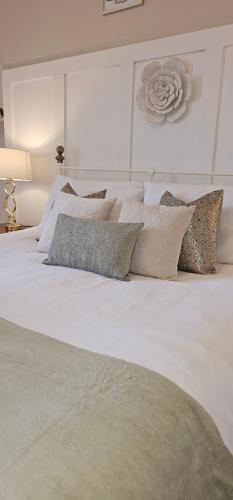 a large white bed with pillows on top of it at Antfield house in Inverness