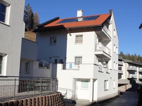 a white building with a red roof at Modern Apartment in Fiss at Ski Bus Stop in Fiss